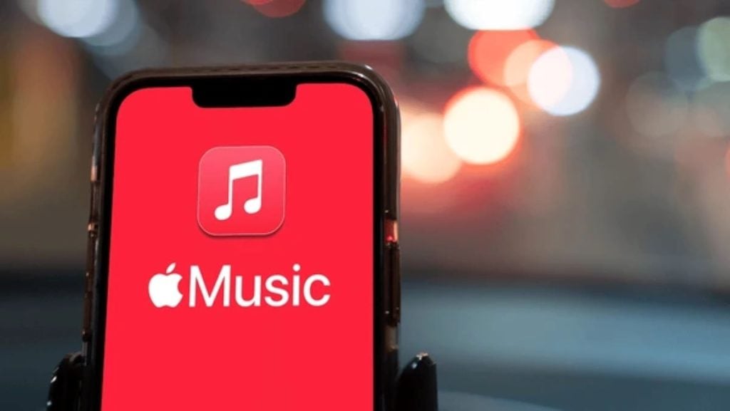 An iPhone screen displaying the Apple Music app logo with a white music note on a red background.