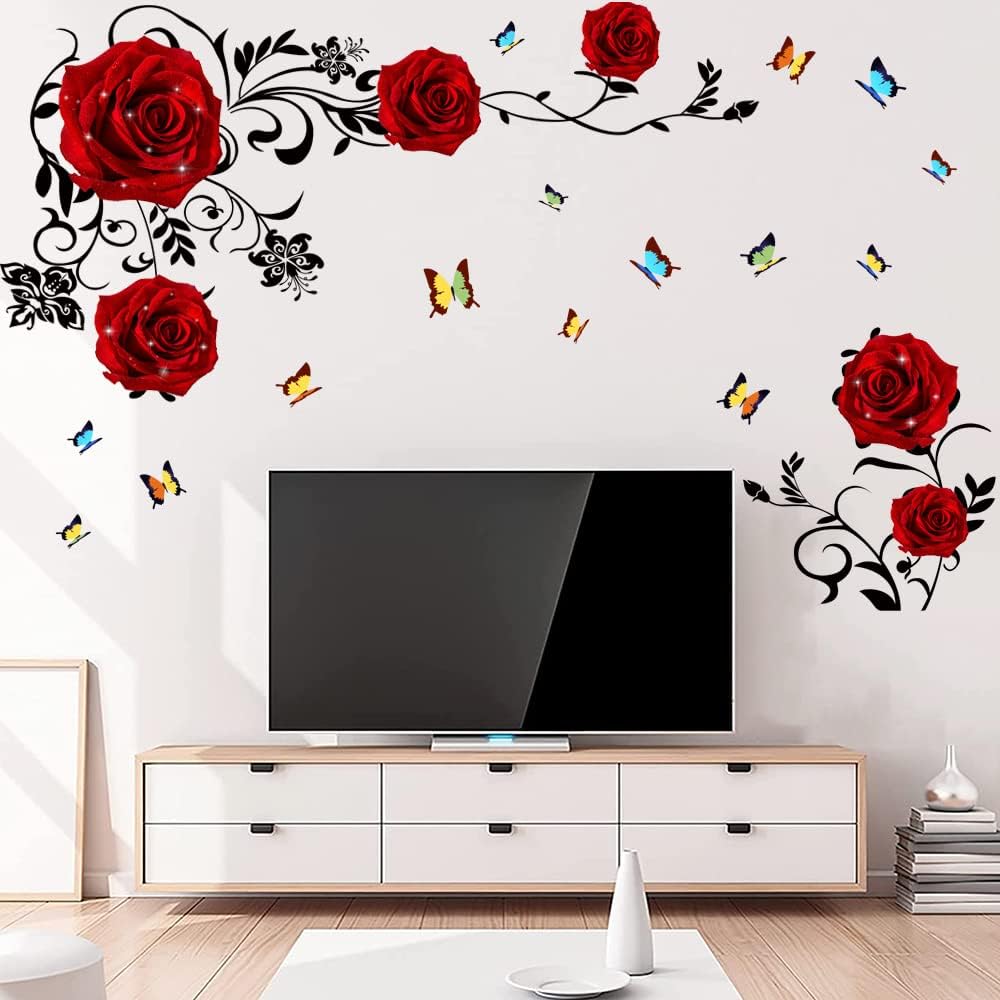 TV console with red rose, butterfly, and black vine wall decals arranged above and around the television.