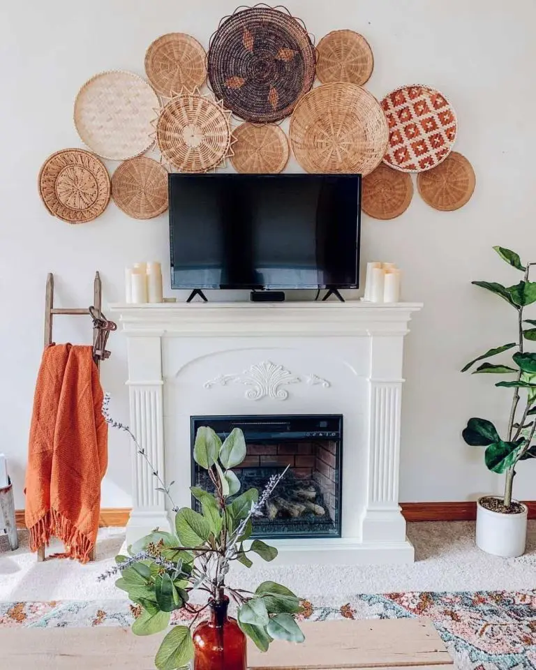 White fireplace mantel with a TV on top and layered woven baskets decorating the wall above it.