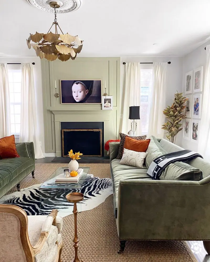 Bright living room with a framed TV above the fireplace, styled to blend in with the surrounding wall decor.
