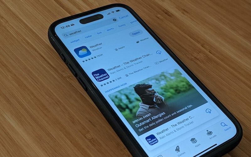 iPhone displaying App Store search results for weather apps including Apple Weather and The Weather Channel.