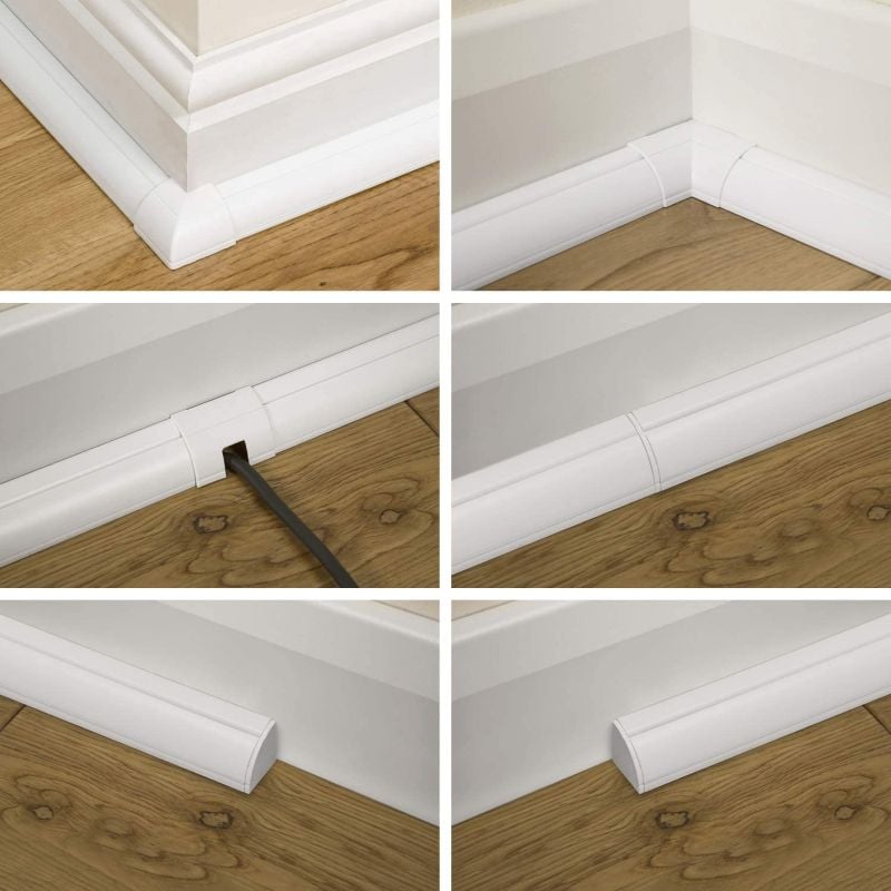 White baseboard cable raceway system with corner, straight, and outlet-access sections installed along a wood floor.